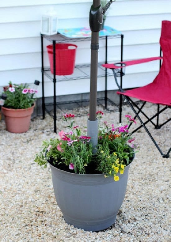 With these 9 DIY Umbrella Stand Planter Ideas, you can grow plants and have shade at the same time!