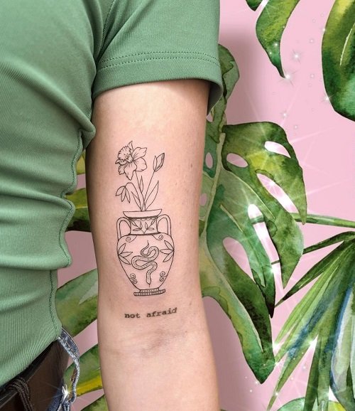 Vase of flowers tattoo on the inner forearm