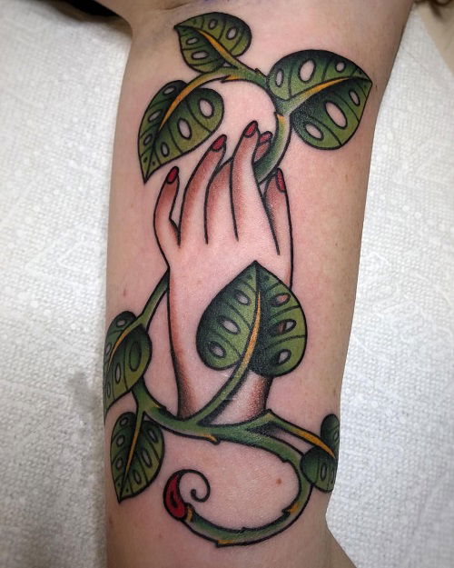 Hand Holding a Monstera Stem tattoo