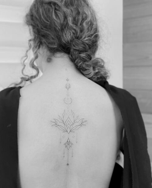 Ornamental Lotus Design Tattoo along the Spine